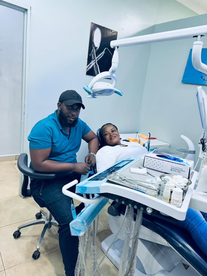 Dr. Mzalendo La-Bouche with a patient at La Bouche Dental Clinic in Wandegeya, Kampala