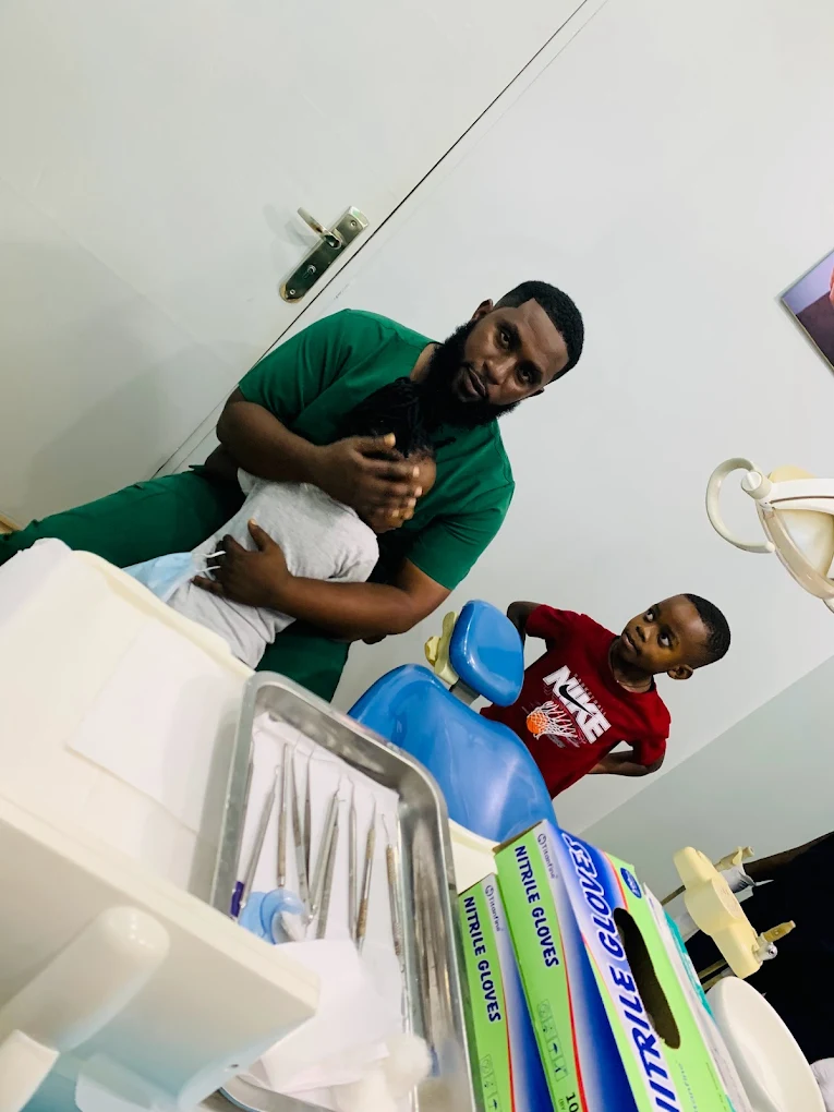 Dr Mzalendo La-Bouche caring for a young patient at La Bouche Dental Clinic